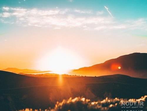 عکس طلوع خورشید از پشت پنجره