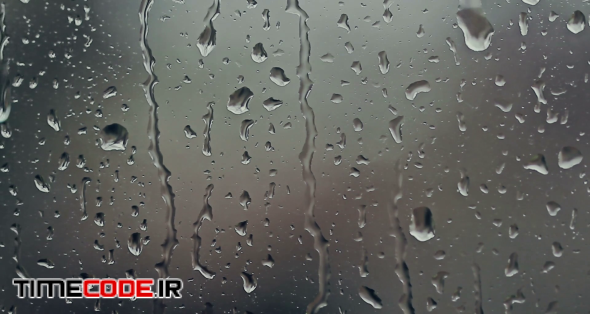 دانلود فوتیج بارش باران روی شیشه Rain Drops On Window 20860 – تایم کد