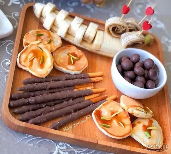 تزیین میز مزه ساده با میوه و چیپس پفک برای مهمانی و تولد