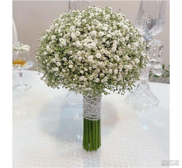 دسته گل زیبای عروس با گل های صد تومانی سفید رنگ بسته شده با تور مروارید ... دسته گل زیبای عروس با گل های صد تومانی سفید رنگ بسته شده با تور مروارید ...
