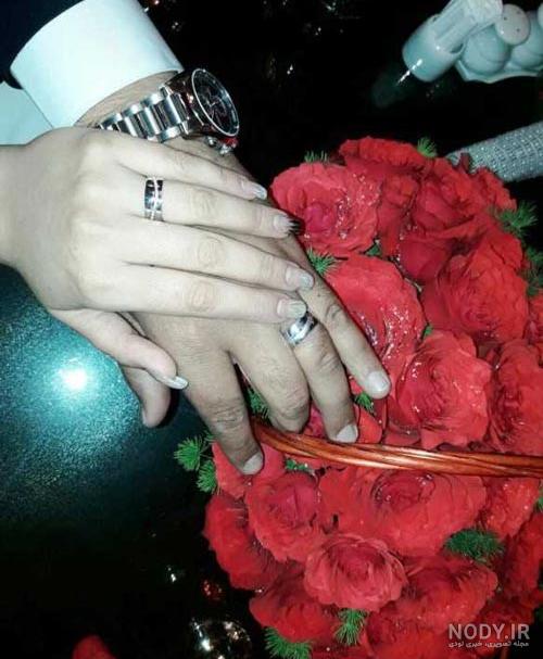 عکس حلقه های ازدواج روی یک دسته گل با گل های صورتی و سفید – عکس با کیفیت و  تصاویر استوک حرفه ای