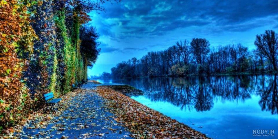 عکس با کیفیت بالا طبیعت زیبای آبشار و دریاچه با درختان و کوه های زیبا در  تابستان و آسمان آبی یا دانلود عکس با کیفیت طبیعت بکر و کوه و جنگل و